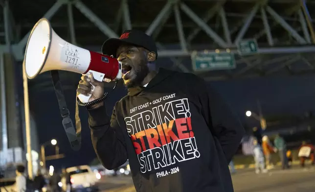 Third generation longshoreman Ray Bailey Jr. trustee of ILA Local 1291 encourages picketers outside the Packer Avenue Marine Terminal Port, Tuesday, Oct. 1, 2024.(AP Photo/Ryan Collerd)