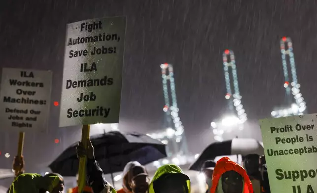 Hundreds of longshoremen strike together outside of the Virginia International Gateway in Portsmouth, Va., Tuesday, Oct. 1, 2024. (Billy Schuerman/The Virginian-Pilot via AP)