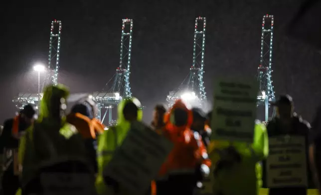 Hundreds of longshoremen strike together outside of the Virginia International Gateway in Portsmouth, Va., Tuesday, Oct. 1, 2024. (Billy Schuerman/The Virginian-Pilot via AP)