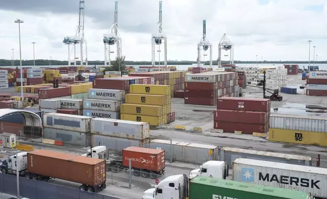 Dockworkers return to work at Port Miami, after the union representing 45,000 striking U.S. dockworkers reached a deal to suspend a three-day strike, Friday, Oct. 4, 2024, in Miami. (AP Photo/Marta Lavandier)