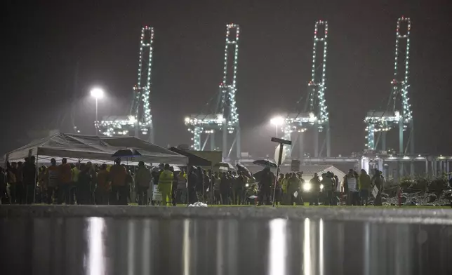 Hundreds of longshoremen strike together outside of the Virginia International Gateway in Portsmouth, Va., Tuesday, Oct. 1, 2024. (Billy Schuerman/The Virginian-Pilot via AP)