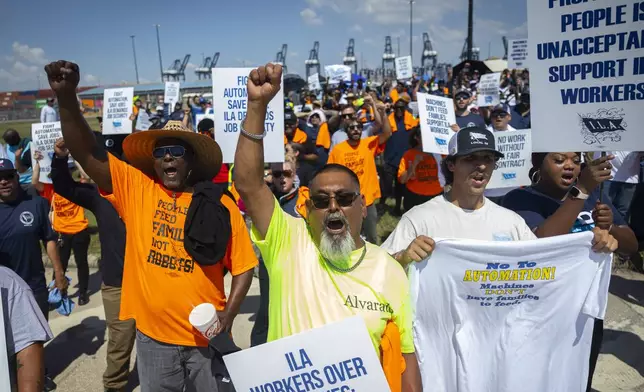 Francisco Alvarado, center, joins other ILA members during a strike at the Bayport Container Terminal on Tuesday, Oct. 1, 2024, in Houston. (AP Photo/Annie Mulligan)