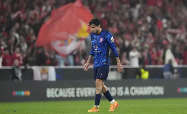 Atletico Madrid's Jose Gimenez walks on the pitch after the end of a Champions League opening phase soccer match between SL Benfica and Atletico Madrid in Lisbon, on Wednesday, Oct. 2, 2024. Benfica won 4-0.(AP Photo/Armando Franca)