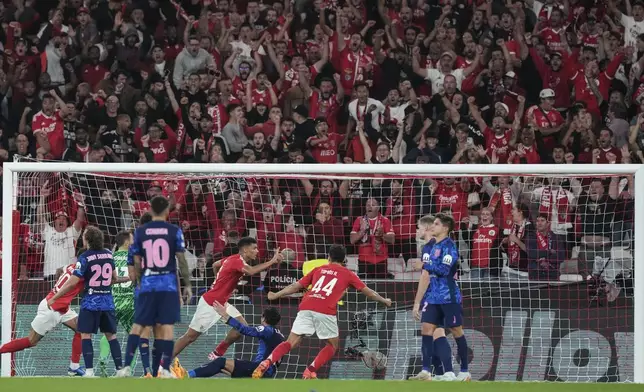 Benfica's Alexander Bah, forth right, celebrates after scoring his sides third goal during a Champions League opening phase soccer match between SL Benfica and Atletico Madrid in Lisbon, on Wednesday, Oct. 2, 2024.(AP Photo/Armando Franca)