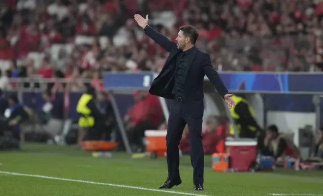 Atletico Madrid's head coach Diego Simeone gives instructions to his players during of a Champions League opening phase soccer match between SL Benfica and Atletico Madrid in Lisbon, on Wednesday, Oct. 2, 2024.(AP Photo/Armando Franca)