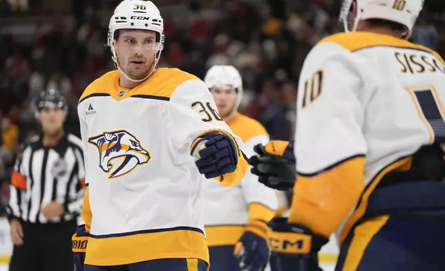 Nashville Predators left wing Cole Smith, left, and center Colton Sissons celebrate their teams 3-2 win over the Chicago Blackhawks in an NHL hockey game Friday, Oct. 25, 2024, in Chicago. (AP Photo/Erin Hooley)