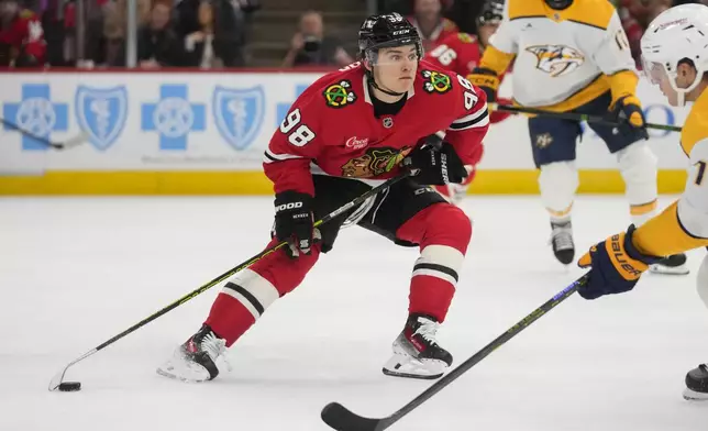 Chicago Blackhawks center Connor Bedard (98) handles the puck during the second period of an NHL hockey game against the Nashville Predators, Friday, Oct. 25, 2024, in Chicago. (AP Photo/Erin Hooley)