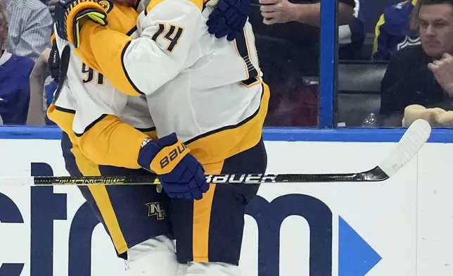 Nashville Predators center Gustav Nyquist (14) celebrates his goal against the Tampa Bay Lightning with center Steven Stamkos (91) during the second period of an NHL hockey game Monday, Oct. 28, 2024, in Tampa, Fla. (AP Photo/Chris O'Meara)