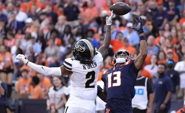 Purdue defensive back Nyland Green (2) tips the ball away from Illinois wide receiver Pat Bryant during the second half of an NCAA college football game Saturday, Oct. 12, 2024, in Champaign, Ill. (AP Photo/Charles Rex Arbogast)