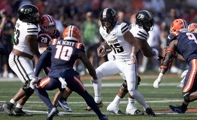 Purdue quarterback Ryan Browne carries the ball during the first half of an NCAA college football game against Illinois on Saturday, Oct. 12, 2024, in Champaign, Ill. (AP Photo/Charles Rex Arbogast)