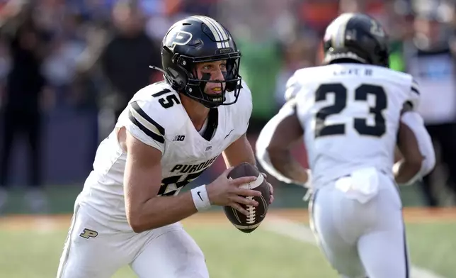 Purdue quarterback Ryan Browne carries the ball during the first half of an NCAA college football game against Illinois on Saturday, Oct. 12, 2024, in Champaign, Ill. (AP Photo/Charles Rex Arbogast)