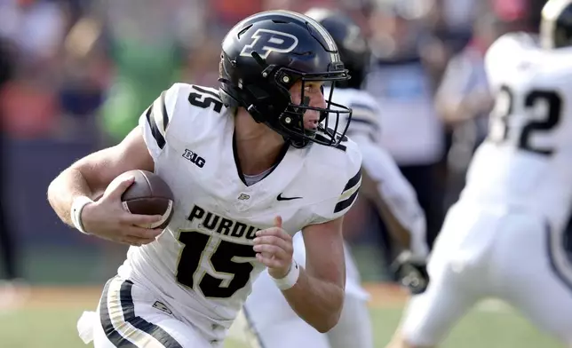 Purdue quarterback Ryan Browne carries the ball during the first half of an NCAA college football game against Illinois on Saturday, Oct. 12, 2024, in Champaign, Ill. (AP Photo/Charles Rex Arbogast)