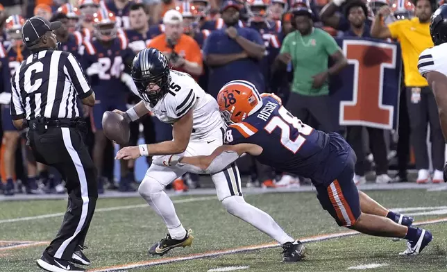 Purdue quarterback Ryan Browne is sacked by Illinois linebacker Dylan Rosiek on a two-point conversion giving Illinois a 50-49 win in overtime during an NCAA college football game Saturday, Oct. 12, 2024, in Champaign, Ill. (AP Photo/Charles Rex Arbogast)