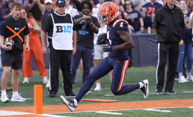 Illinois wide receiver Zakhari Franklin scores on a pass from quarterback Luke Altmyer during the first half of an NCAA college football game against Purdue on Saturday, Oct. 12, 2024, in Champaign, Ill. (AP Photo/Charles Rex Arbogast)