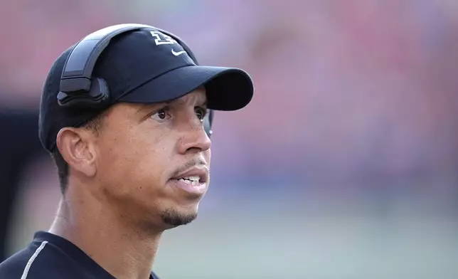 Purdue head coach Ryan Walters watches the video replay screen during the second half of an NCAA college football game against Illinois on Saturday, Oct. 12, 2024, in Champaign, Ill. (AP Photo/Charles Rex Arbogast)