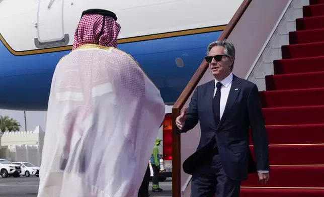 Qatari Ministry of Foreign Affairs Chief of Protocol Ibrahim Fakhroo welcomes U.S. Secretary of State Antony Blinken, right, as he arrives in Doha, Qatar, Thursday, Oct. 24, 2024. (Nathan Howard/Pool Photo via AP)