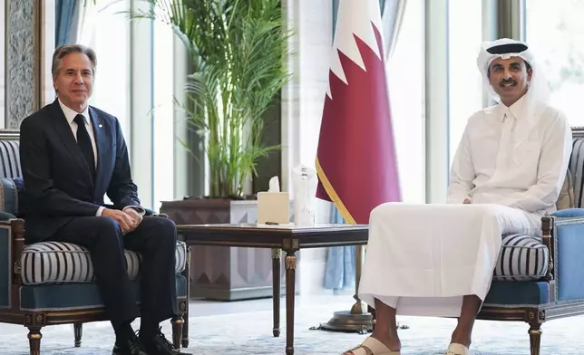 U.S. Secretary of State Antony Blinken, left, meets with Qatar's Emir Sheikh Tamim bin Hamad al-Thani in Doha, Qatar, Thursday, Oct. 24, 2024. (Nathan Howard/Pool Photo via AP)