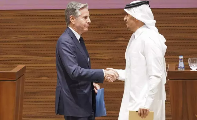 U.S. Secretary of State Antony Blinken, left, and Qatari Prime Minister and Foreign Minister Mohammed bin Abdulrahman Al Thani shake hands as they attend a press conference in Doha, Qatar, Thursday, Oct. 24, 2024. (Nathan Howard/Pool Photo via AP)