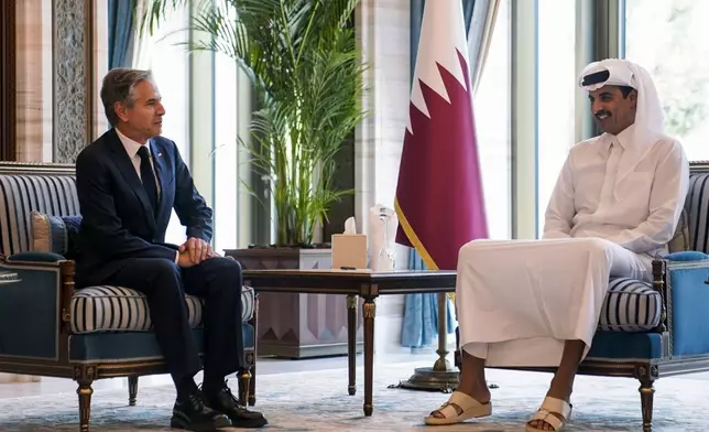 U.S. Secretary of State Antony Blinken, left, meets with Qatar's Emir Sheikh Tamim bin Hamad al-Thani in Doha, Qatar, Thursday, Oct. 24, 2024. (Nathan Howard/Pool Photo via AP)