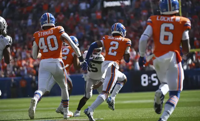 Denver Broncos cornerback Pat Surtain II (2) intercepts a pass and returns it for a 100-yard touchdown during the first half of an NFL football game against the Las Vegas Raiders, Sunday, Oct. 6, 2024, in Denver. (AP Photo/Geneva Heffernan)