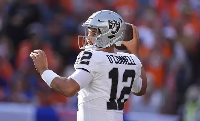 Las Vegas Raiders quarterback Aidan O'Connell throws during the second half of an NFL football game against the Denver Broncos, Sunday, Oct. 6, 2024, in Denver. (AP Photo/David Zalubowski)