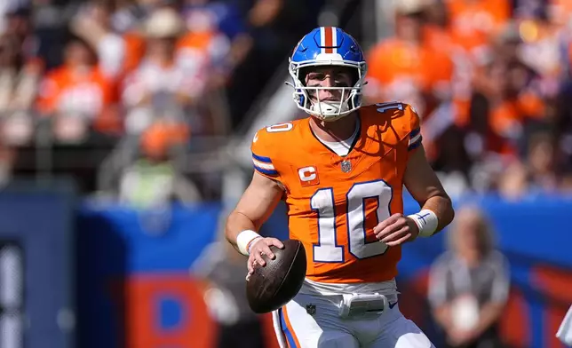 Denver Broncos quarterback Bo Nix looks downfield during the first half of an NFL football game against the Las Vegas Raiders, Sunday, Oct. 6, 2024, in Denver. (AP Photo/David Zalubowski)