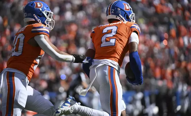 Denver Broncos cornerback Pat Surtain II (2) intercepts a pass and returns it for a 100-yard touchdown during the first half of an NFL football game against the Las Vegas Raiders, Sunday, Oct. 6, 2024, in Denver. (AP Photo/Geneva Heffernan)