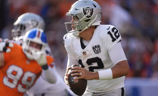 Las Vegas Raiders quarterback Aidan O'Connell looks downfield during the second half of an NFL football game against the Denver Broncos, Sunday, Oct. 6, 2024, in Denver. (AP Photo/David Zalubowski)