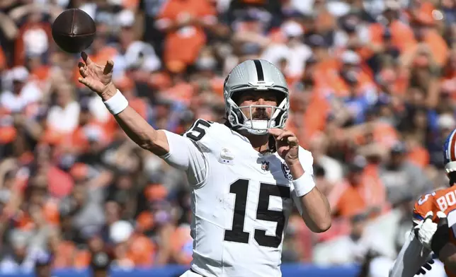 Las Vegas Raiders quarterback Gardner Minshew throws during the first half of an NFL football game against the Denver Broncos, Sunday, Oct. 6, 2024, in Denver. (AP Photo/Geneva Heffernan)