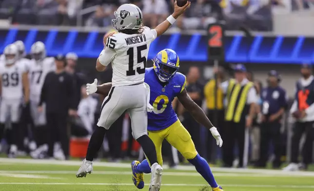 Los Angeles Rams linebacker Byron Young (0) pressures Las Vegas Raiders quarterback Gardner Minshew (15) during the second half of an NFL football game Sunday, Oct. 20, 2024, in Inglewood, Calif. (AP Photo/Ryan Sun)