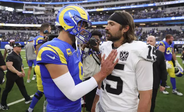 Los Angeles Rams quarterback Matthew Stafford, left, and Las Vegas Raiders quarterback Gardner Minshew (15) meet after an NFL football game Sunday, Oct. 20, 2024, in Inglewood, Calif. (AP Photo/Ryan Sun)