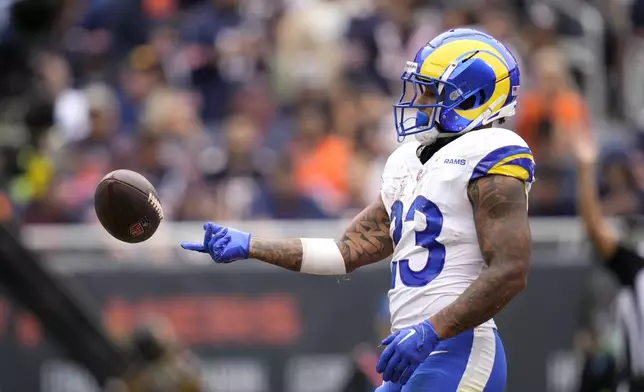 Los Angeles Rams running back Kyren Williams flips the ball to an official after his touchdown during the second half of an NFL football game against the Chicago Bears on Sunday, Sept. 29, 2024, in Chicago. (AP Photo/Erin Hooley)