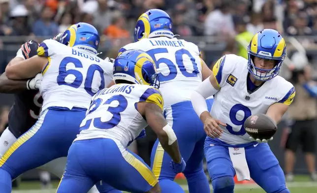 Los Angeles Rams quarterback Matthew Stafford hands the ball off to running back Kyren Williams during the first half of an NFL football game against the Chicago Bears on Sunday, Sept. 29, 2024, in Chicago. (AP Photo/Erin Hooley)