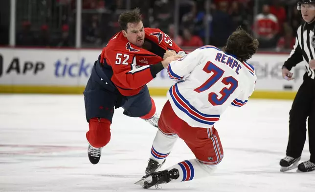 New York Rangers center Matt Rempe (73) and Washington Capitals defenseman Dylan McIlrath (52) fight during the first period of an NHL hockey game, Tuesday, Oct. 29, 2024, in Washington. (AP Photo/Nick Wass)