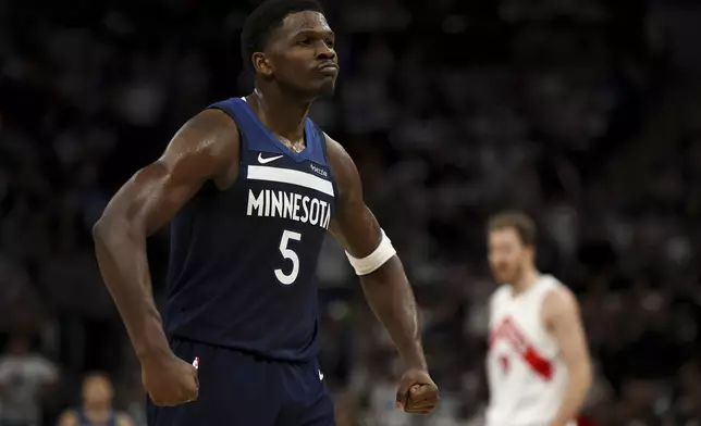 Minnesota Timberwolves guard Anthony Edwards (5) celebrates a score during the first half of an NBA basketball game against the Toronto Raptors, Saturday, Oct. 26, 2024, in Minneapolis. (AP Photo/Ellen Schmidt)