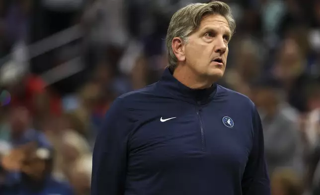 Minnesota Timberwolves head coach Chris Finch brings his team into a timeout during the first half of an NBA basketball game against the Toronto Raptors, Saturday, Oct. 26, 2024, in Minneapolis. (AP Photo/Ellen Schmidt)