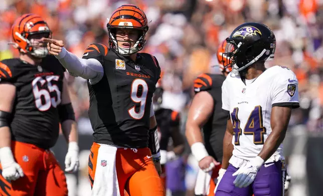 Cincinnati Bengals quarterback Joe Burrow (9) gestures in front of Baltimore Ravens cornerback Marlon Humphrey (44) following a play during the second half of an NFL football game, Sunday, Oct. 6, 2024, in Cincinnati. (AP Photo/Jeff Dean)