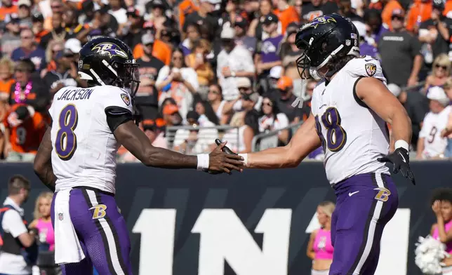 Baltimore Ravens quarterback Lamar Jackson (8) and tight end Charlie Kolar (88) react after they connected for a touchdown pass and catch against the Cincinnati Bengals during the second half of an NFL football game, Sunday, Oct. 6, 2024, in Cincinnati. (AP Photo/Jeff Dean)