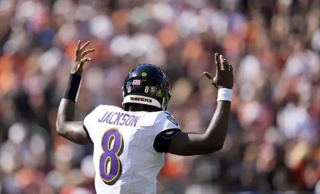 Baltimore Ravens quarterback Lamar Jackson reacts after teammate Derrick Henry scored on a touchdown run against the Cincinnati Bengals during the first half of an NFL football game, Sunday, Oct. 6, 2024, in Cincinnati. (AP Photo/Carolyn Kaster)