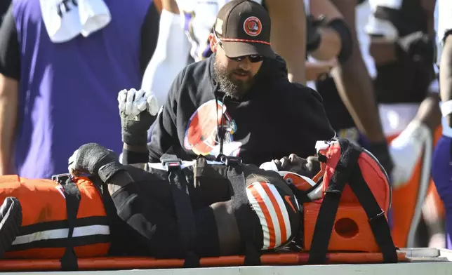 Cleveland Browns linebacker Jeremiah Owusu-Koramoah (6) is taken off the field during the second half of an NFL football game against the Baltimore Ravens in Cleveland, Sunday, Oct. 27, 2024. (AP Photo/David Richard)