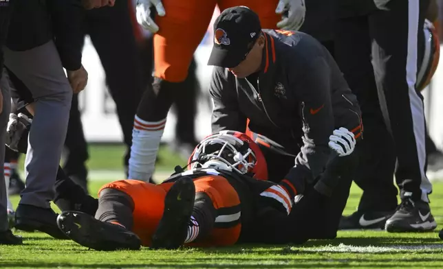 Cleveland Browns linebacker Jeremiah Owusu-Koramoah (6) is checked on the field during the second half of an NFL football game against the Baltimore Ravens in Cleveland, Sunday, Oct. 27, 2024. (AP Photo/David Richard)