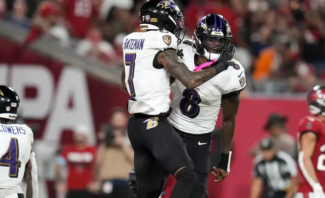 Baltimore Ravens wide receiver Rashod Bateman (7) and quarterback Lamar Jackson (8) celebrate after Bateman's touchdown during the second half of an NFL football game, Monday, Oct. 21, 2024, in Tampa, Fla. (AP Photo/Chris O'Meara)