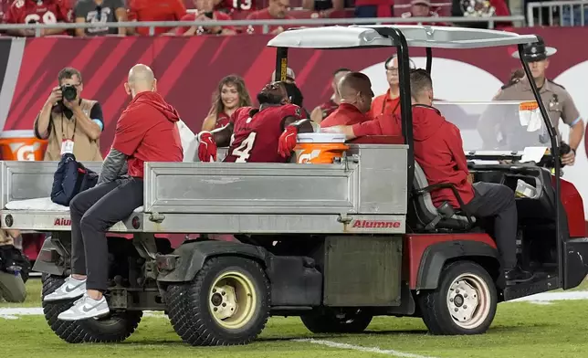 Tampa Bay Buccaneers wide receiver Chris Godwin (14) is carted off of the field after an injury during the second half of an NFL football game against the Baltimore Ravens, Monday, Oct. 21, 2024, in Tampa, Fla. (AP Photo/Chris O'Meara)