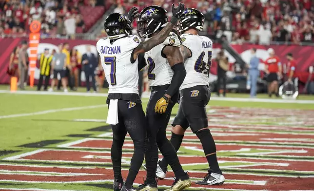 Baltimore Ravens wide receiver Rashod Bateman (7) celebrates with running back Derrick Henry (22) after Henry's passing touchdown during the second half of an NFL football game against the Tampa Bay Buccaneers, Monday, Oct. 21, 2024, in Tampa, Fla. (AP Photo/Chris O'Meara)