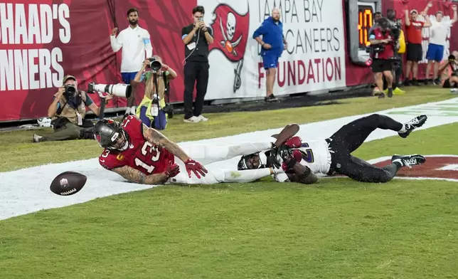 Baltimore Ravens cornerback Brandon Stephens (21) breaks up a pass intended for Tampa Bay Buccaneers wide receiver Mike Evans (13) during the first half of an NFL football game, Monday, Oct. 21, 2024, in Tampa, Fla. (AP Photo/Chris O'Meara)