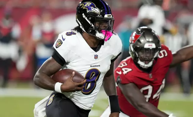 Baltimore Ravens quarterback Lamar Jackson (8) runs past Tampa Bay Buccaneers cornerback Bryce Hall (34) during the first half of an NFL football game, Monday, Oct. 21, 2024, in Tampa, Fla. (AP Photo/Chris O'Meara)