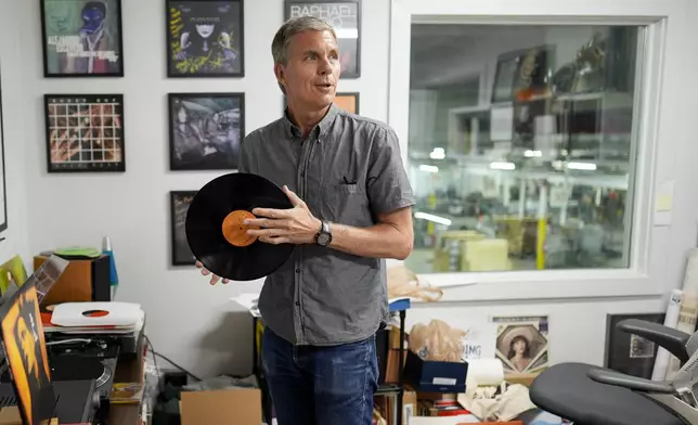 Mark Michaels, CEO &amp; Chairman of United Record Pressing, hold a vinyl recored in his office July 11, 2024, in Nashville, Tenn. (AP Photo/George Walker IV)