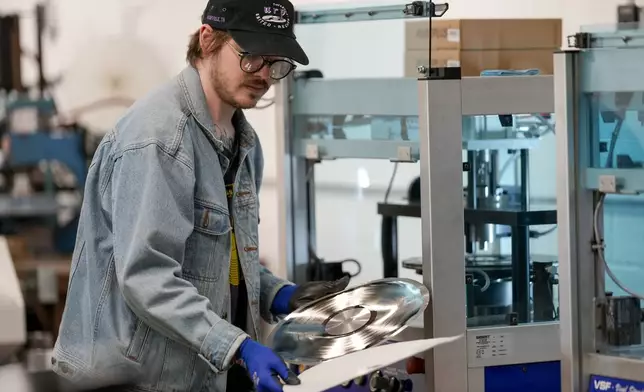 Graham Purrell prepares a master plate for creating vinyl records at the United Record Pressing plant July 11, 2024, in Nashville, Tenn. (AP Photo/George Walker IV)