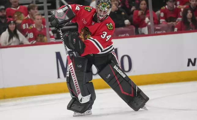 Chicago Blackhawks goaltender Petr Mrazek (34) clears the puck during the second period of an NHL hockey game against the Detroit Red Wings, Wednesday, Sept. 25, 2024, in Chicago. (AP Photo/Erin Hooley)