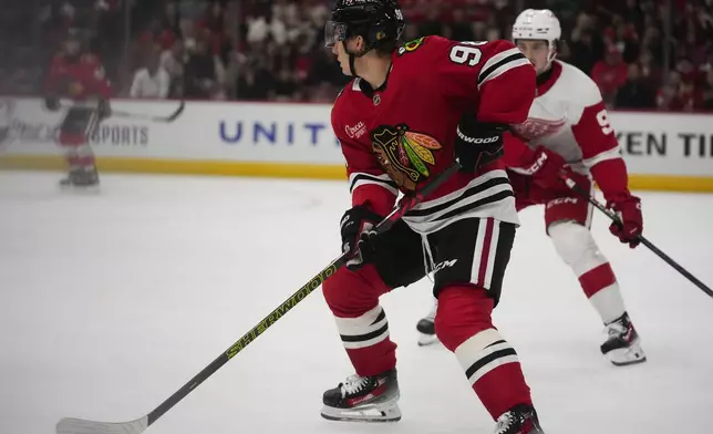 Chicago Blackhawks center Connor Bedard (98) handles the puck during the first period of an NHL hockey game against the Detroit Red Wings, Wednesday, Sept. 25, 2024, in Chicago. (AP Photo/Erin Hooley)